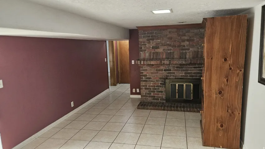 Red brick fireplace with a dark metal firebox