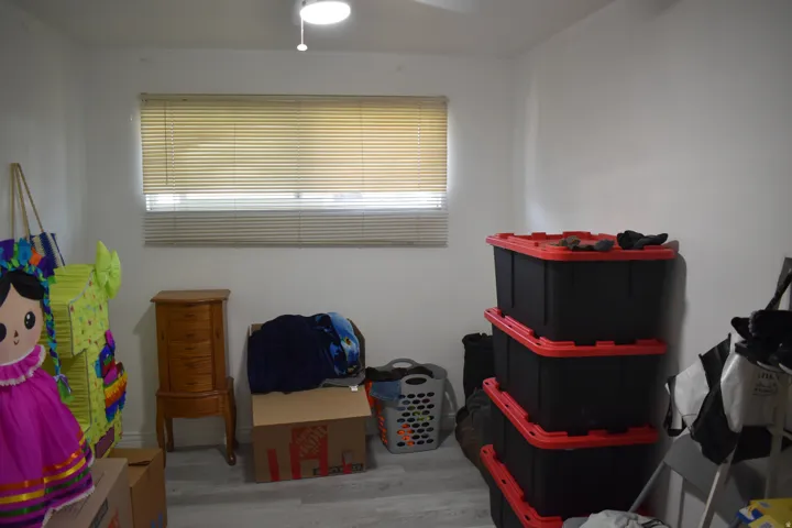 Recessed lighting fixture, window with horizontal blinds, and wood-finish flooring