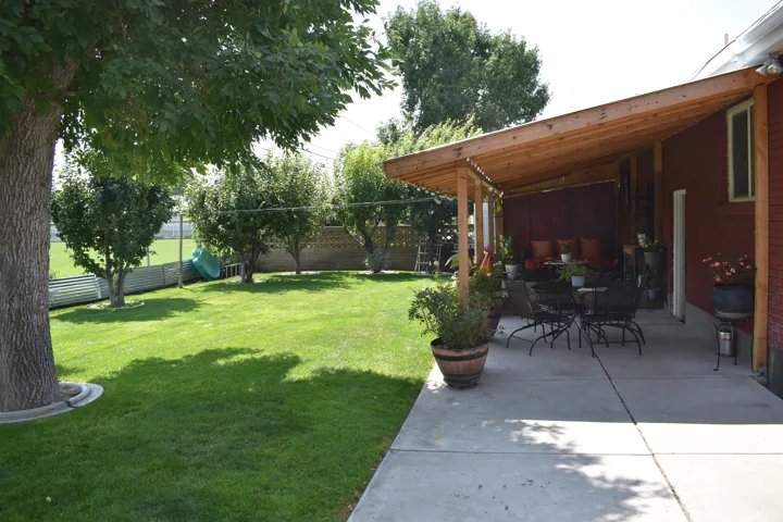 Expansive concrete patio with a wood-framed pergola