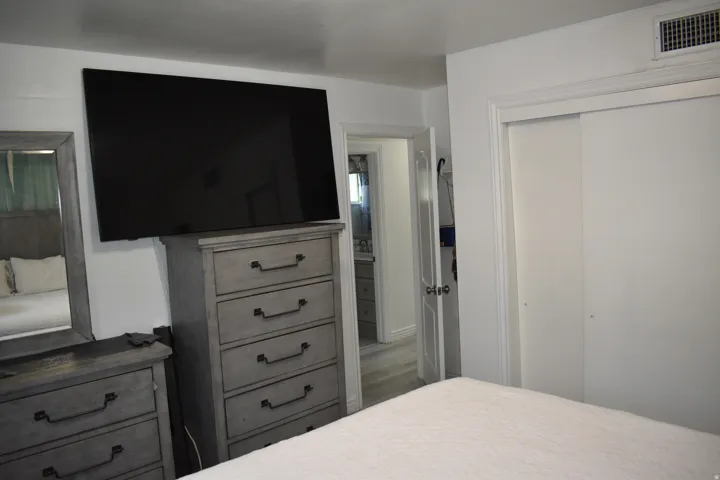 Recessed lighting, white interior door, and built-in closet with sliding doors