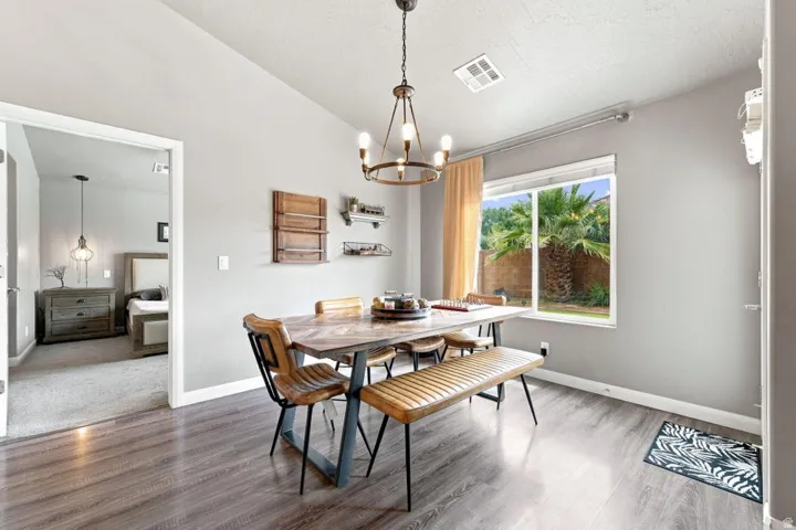 Wood-finish flooring, recessed lighting, and a large window overlooking exterior landscaping