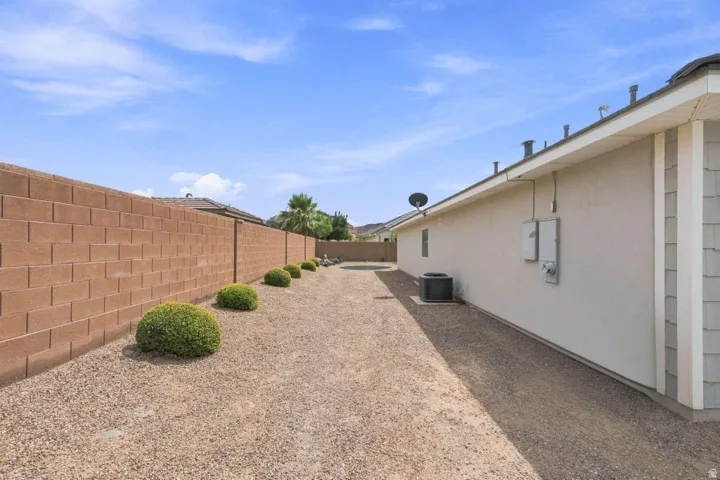 Low-maintenance landscaping featuring gravel ground cover and manicured shrubs