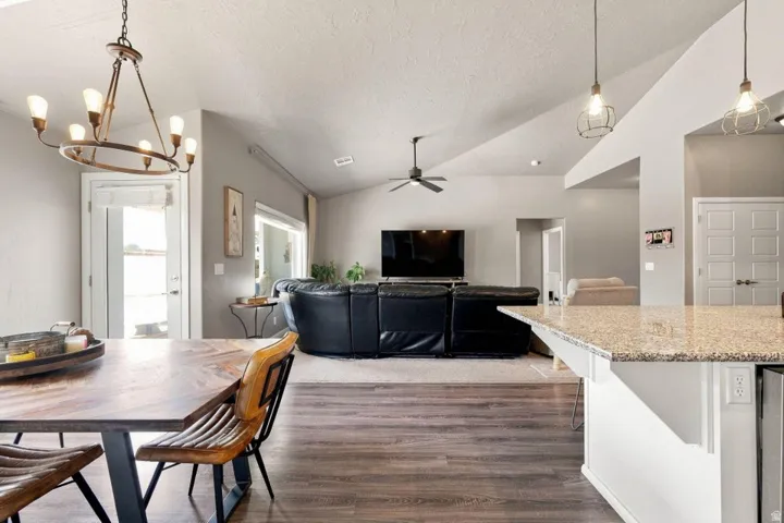 Open-concept living space with vaulted ceilings and wood-finish flooring