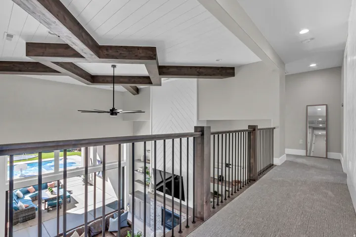 Exposed wood-finish beams accentuating a shiplap ceiling