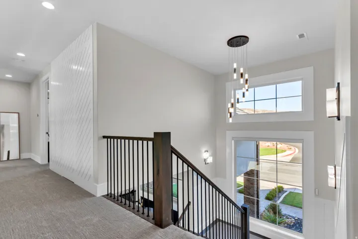 Black metal baluster railing with a dark wood newel post
