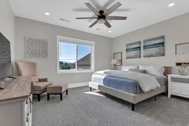 Bright room with light gray walls, recessed lighting, and a ceiling fan