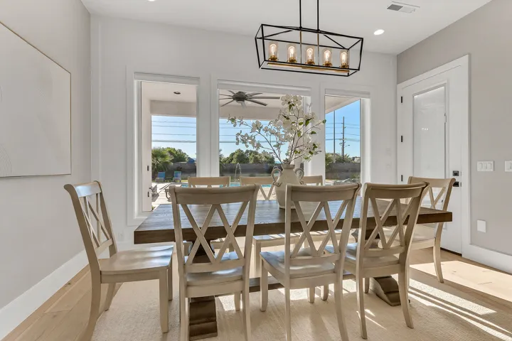Wide plank wood-finish flooring, recessed lighting, and a modern rectangular chandelier