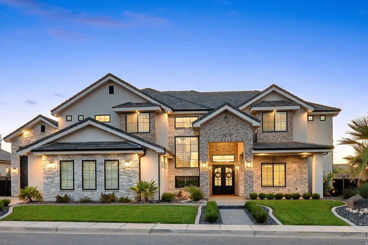 Stucco and stone exterior with a multi-gabled roofline