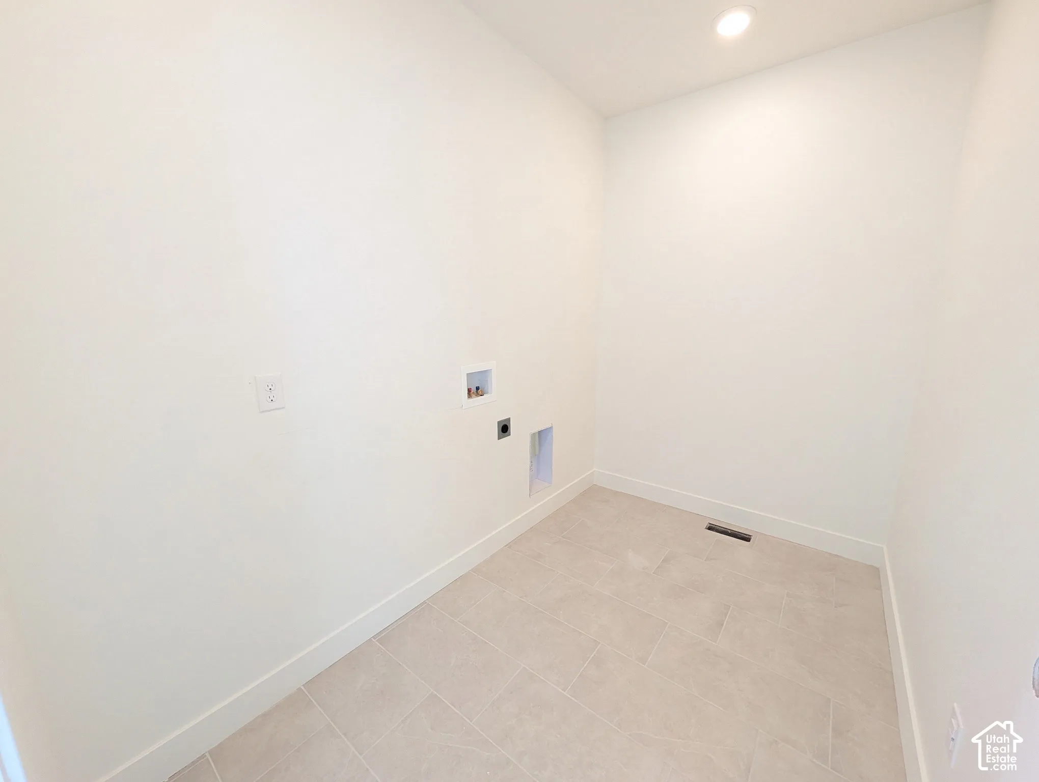 Recessed ceiling lighting, tiled flooring, and white baseboards