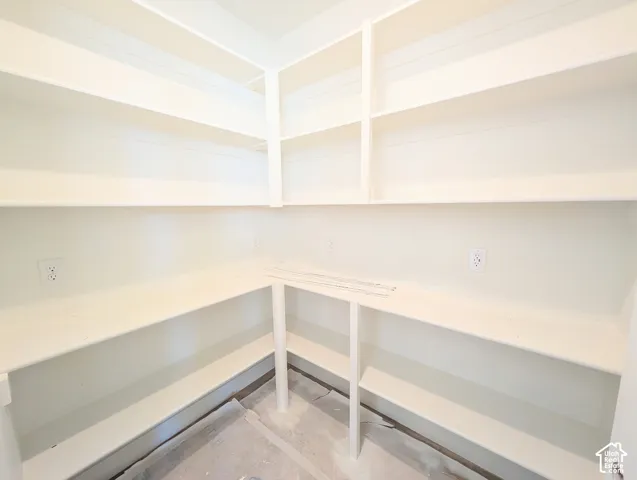 Built-in shelving with multiple levels, white finish, and electrical outlets
