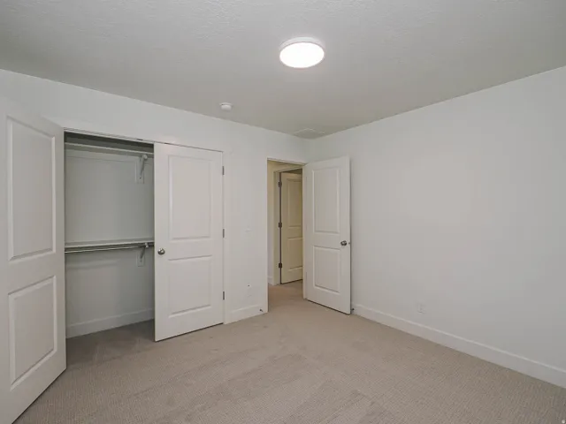 Wall-to-wall carpeting and white painted walls