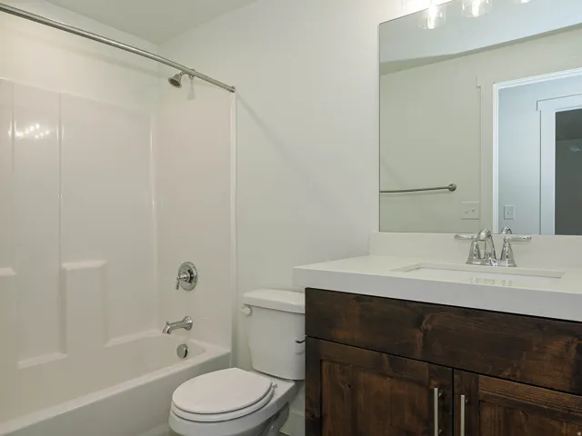 White tub and shower combination with chrome fixtures