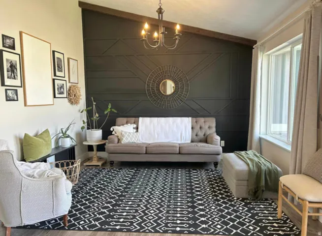Vaulted ceiling featuring a wood beam and chandelier