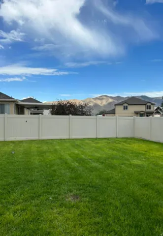 Expansive green lawn with a perimeter fence