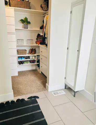 Built-in closet shelving, integrated drawers, and dedicated shoe storage