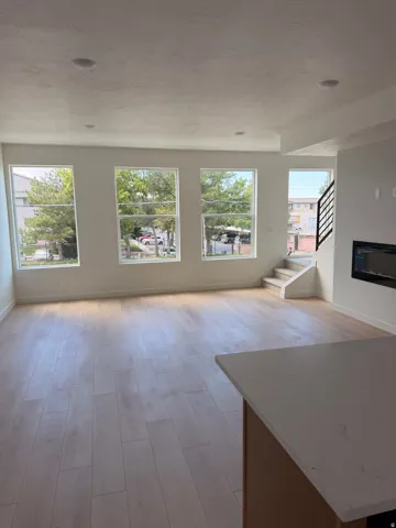Wood-finish LVP flooring, recessed lighting, and multiple windows