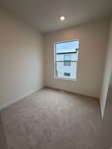Recessed lighting and a white trim package complement the neutral wall finishes and carpeting