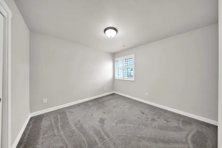 Light gray walls complemented by gray carpeting and a white trim