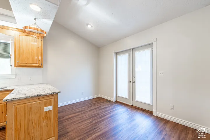 Wood-finish flooring with light-toned walls and white trim