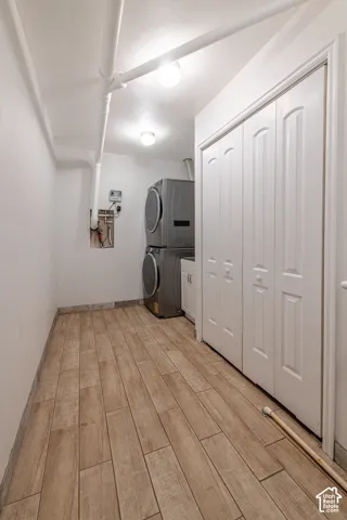 Utility space featuring wood-finish tile flooring, white bi-fold closet doors, and recessed lighting