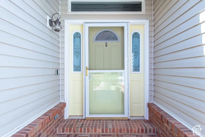 Brick steps and foundation with light-colored siding