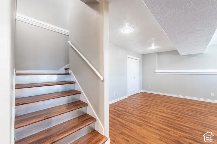 Wood-finish flooring, recessed lighting, and crown molding
