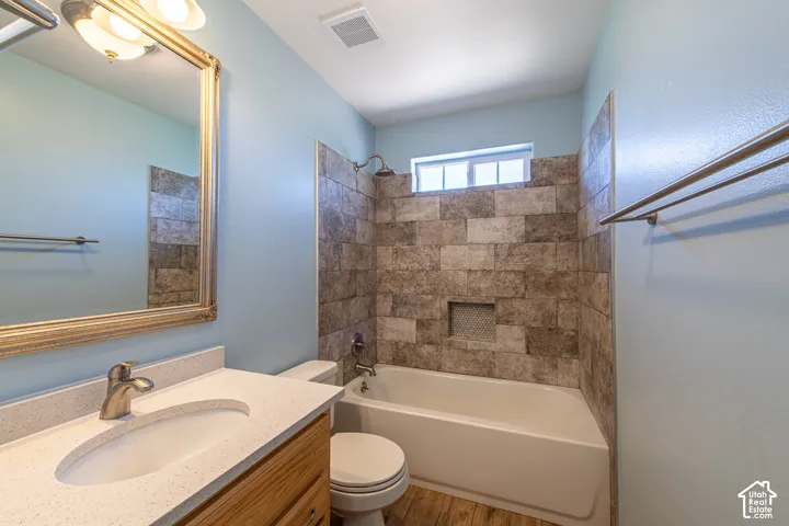 Built-in vanity with light-colored countertop and undermount sink