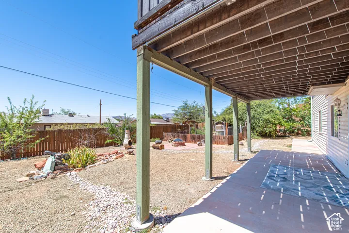 Covered concrete patio with overhead wood beam structure