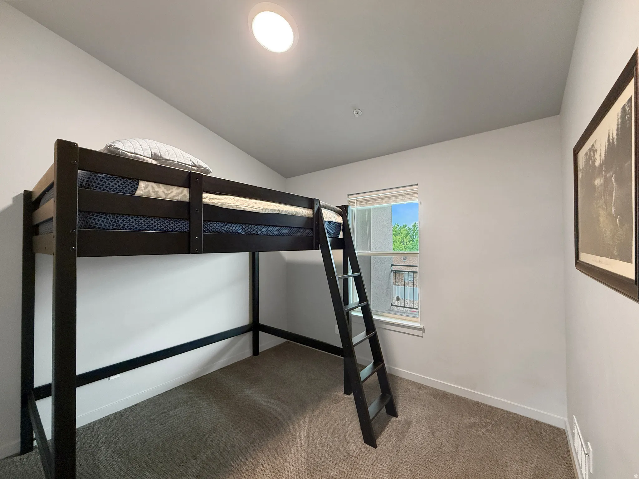 Carpeted room featuring a single window and recessed ceiling light