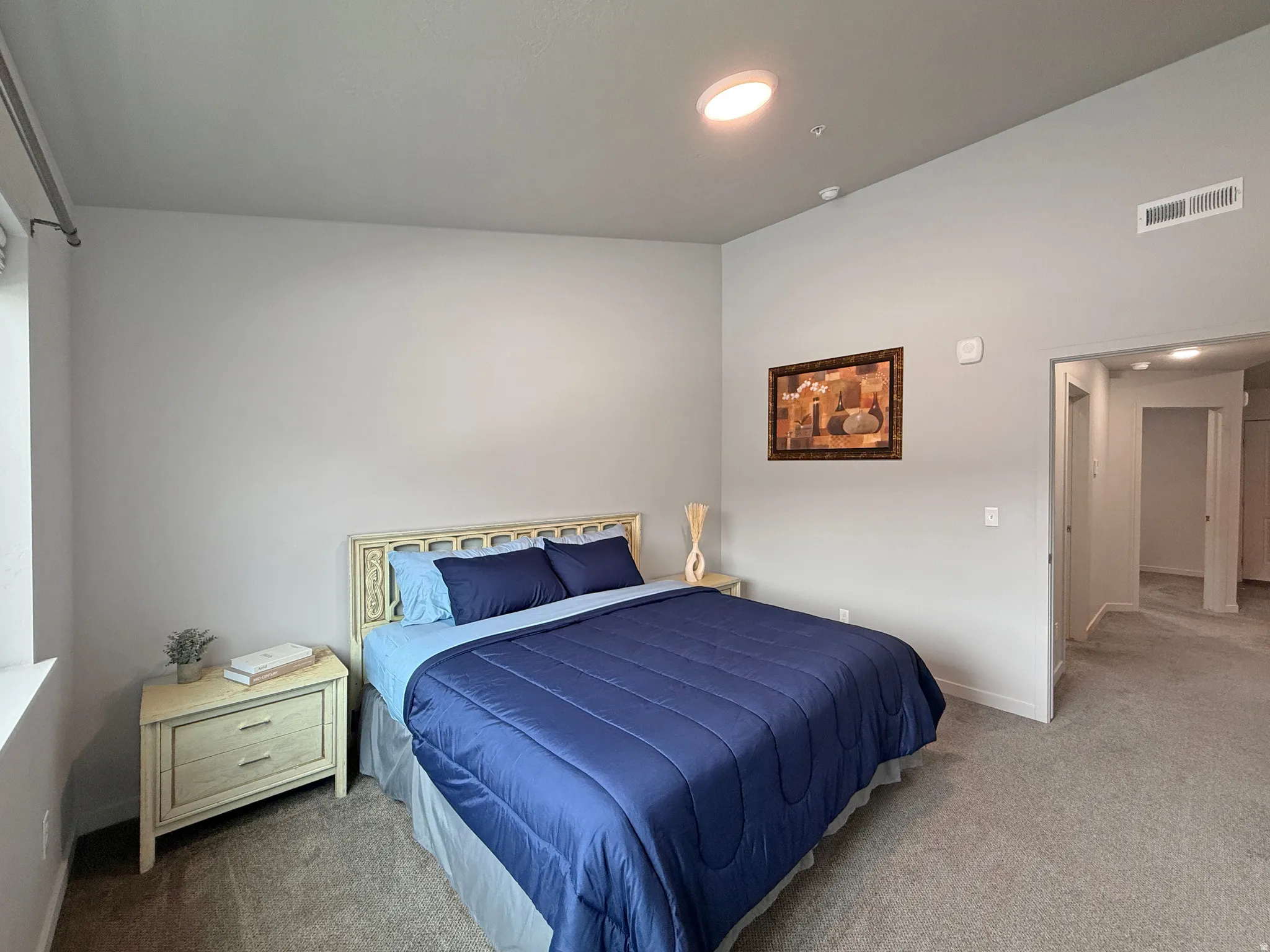 Neutral-toned walls complement the gray carpeting
