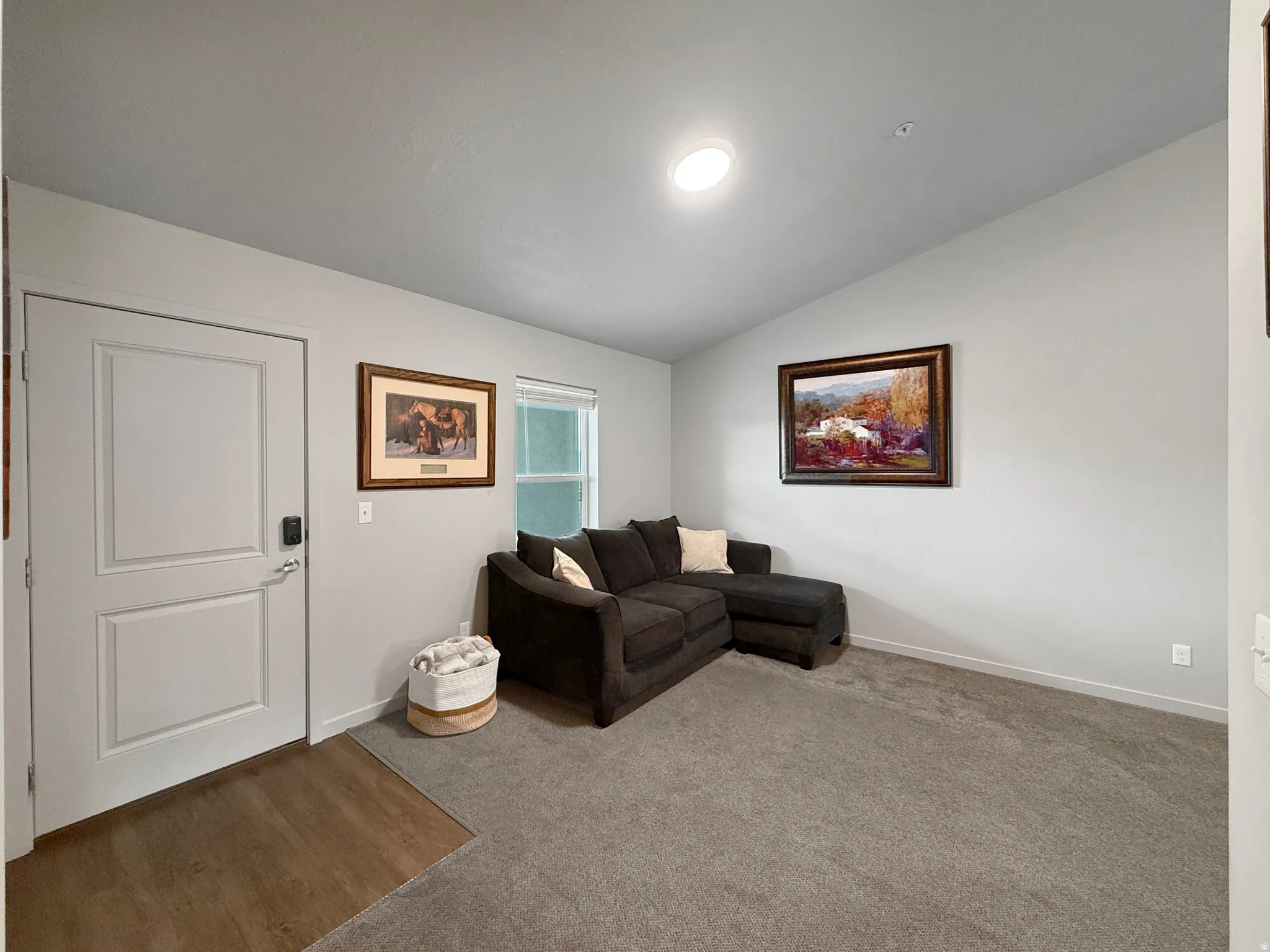 Recessed lighting, wood-finish flooring, light grey carpeting, white interior door, and window with blinds