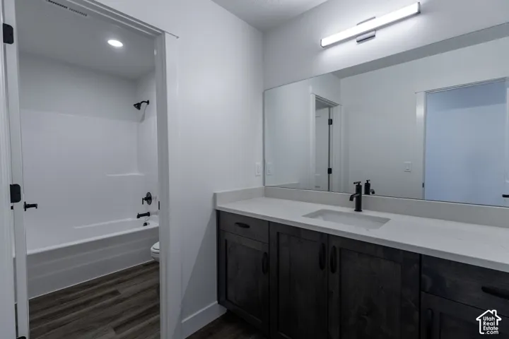 Contemporary vanity with a rectangular undermount sink, light-toned countertop, and matte black faucet