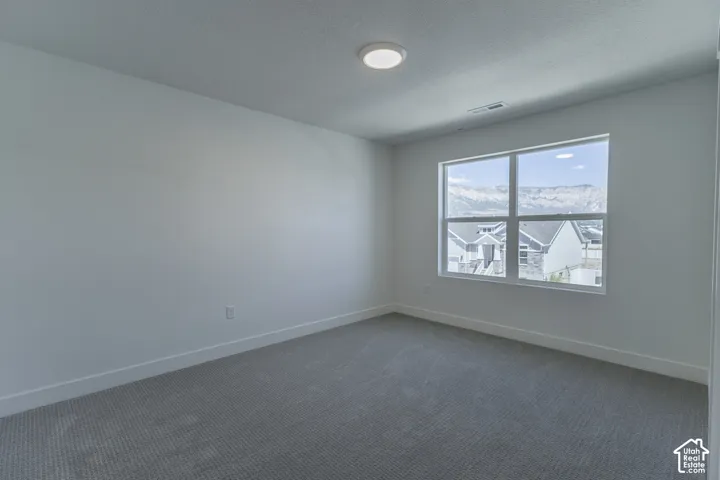 Recessed lighting, large window, carpeted flooring, and neutral wall finishes