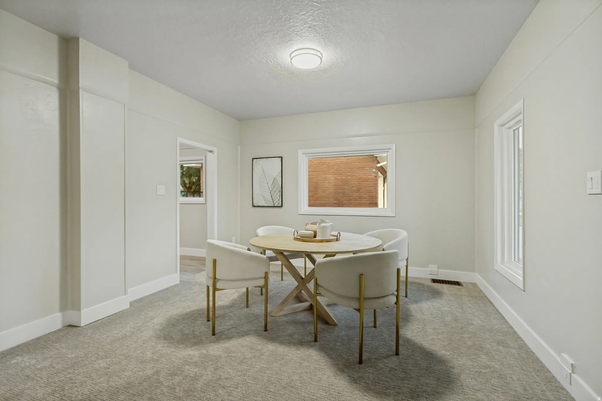Carpeted room with light-toned walls, white trim, and a flush-mount ceiling light fixture