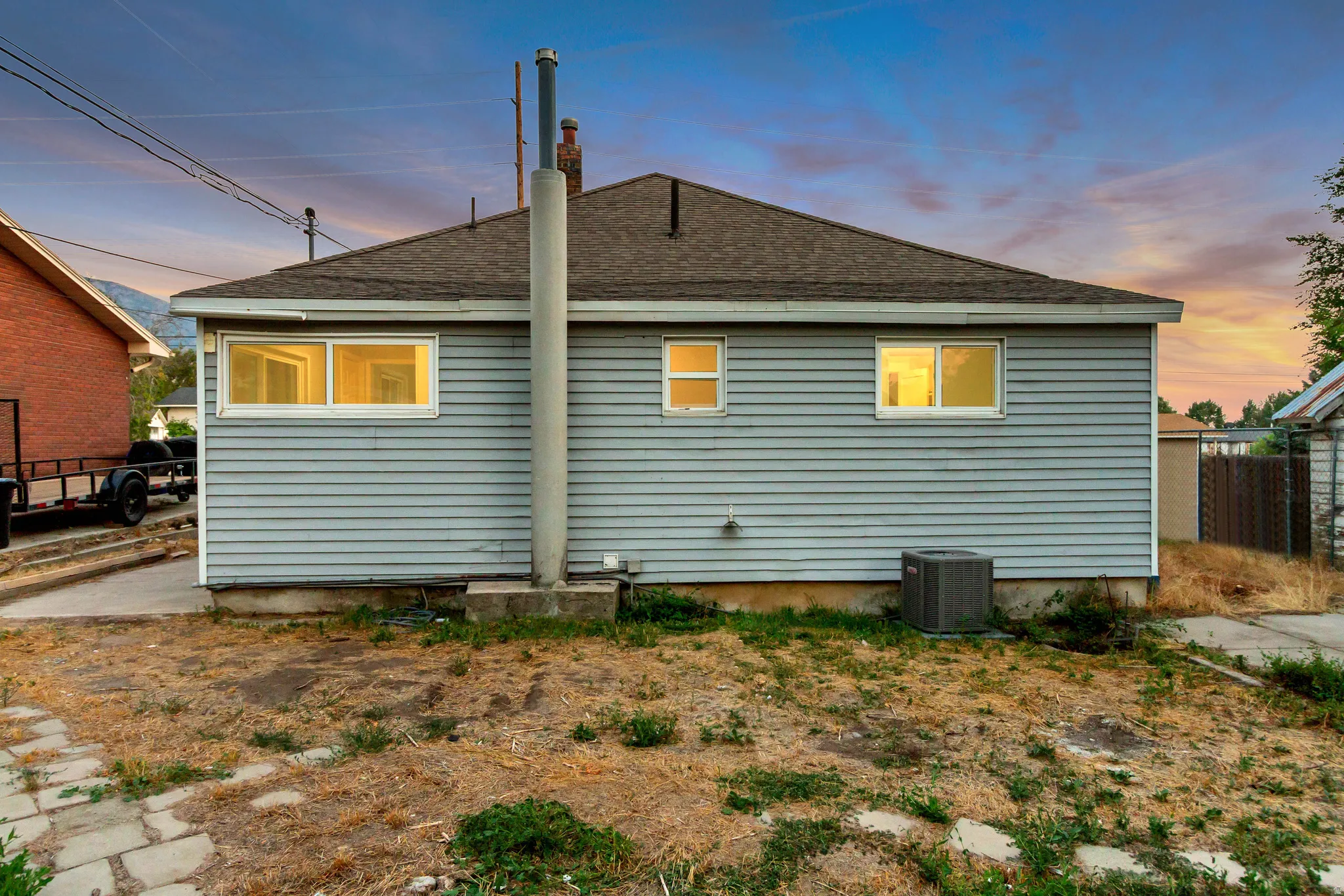 Light blue horizontal siding exterior with a dark-shingled roof