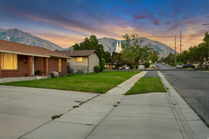 Brick exterior with a brown roof and a concrete driveway