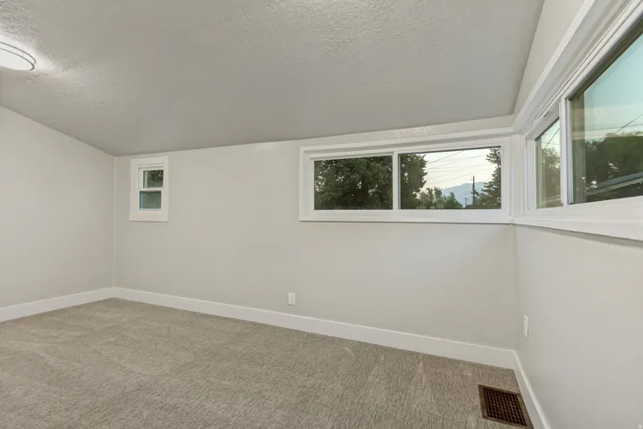 Corner room with light gray carpet and white walls