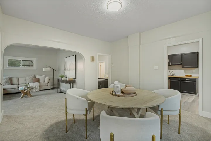 Open-concept living space with light gray carpet and recessed lighting
