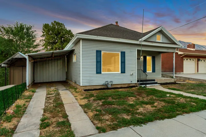Light gray siding exterior with blue window shutters