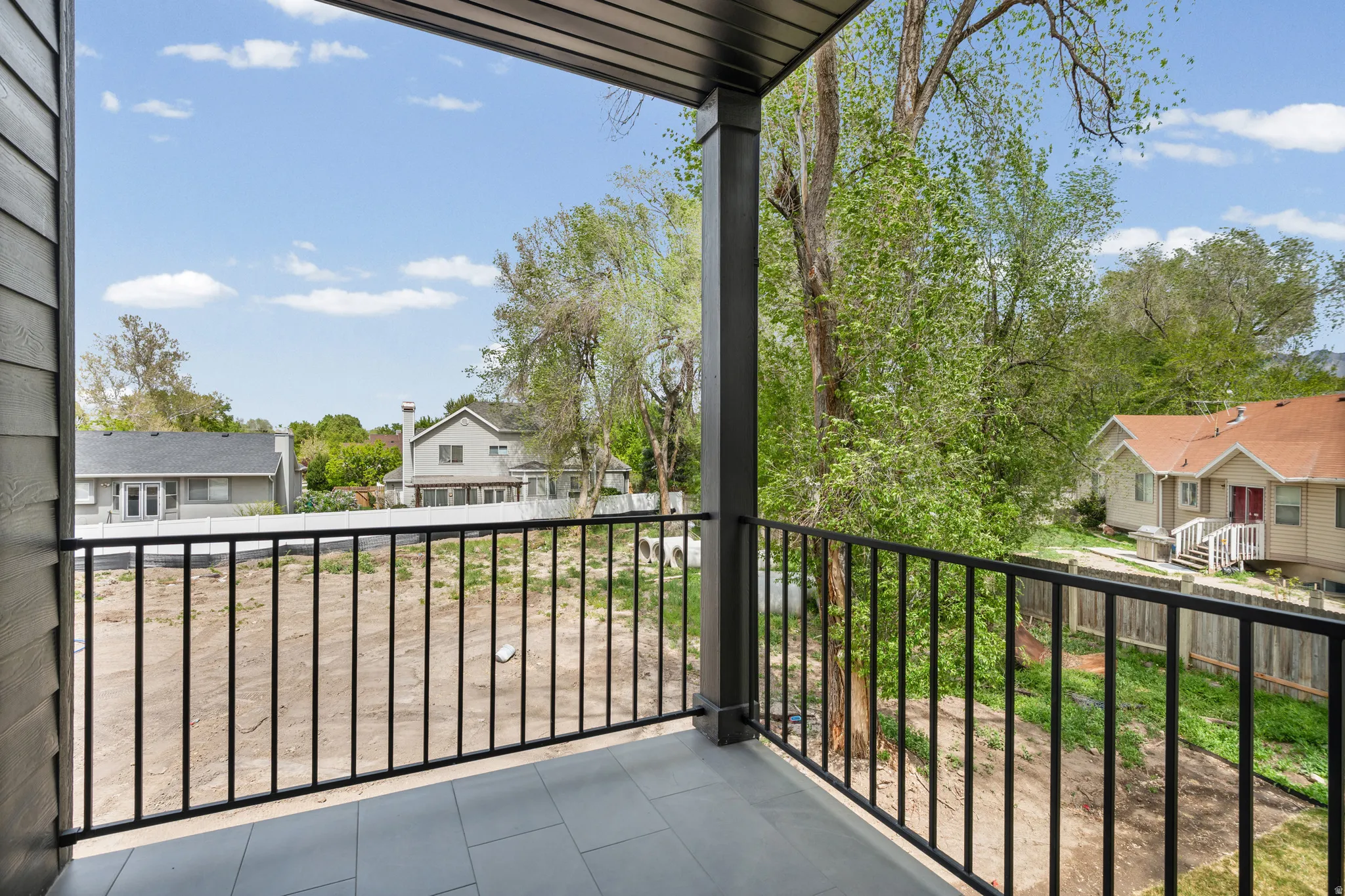 Balcony with tile flooring and black metal railing