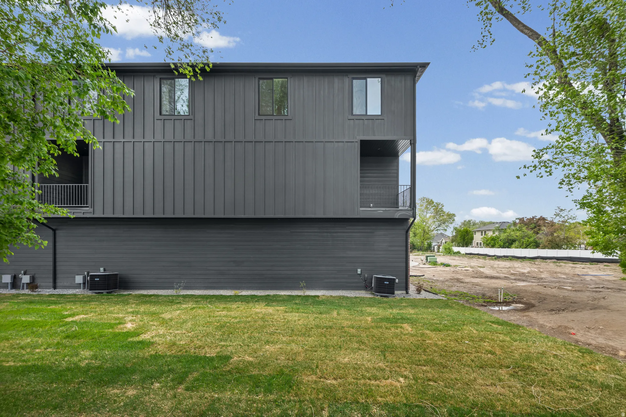 Modern exterior with dark vertical panel siding and horizontal paneling