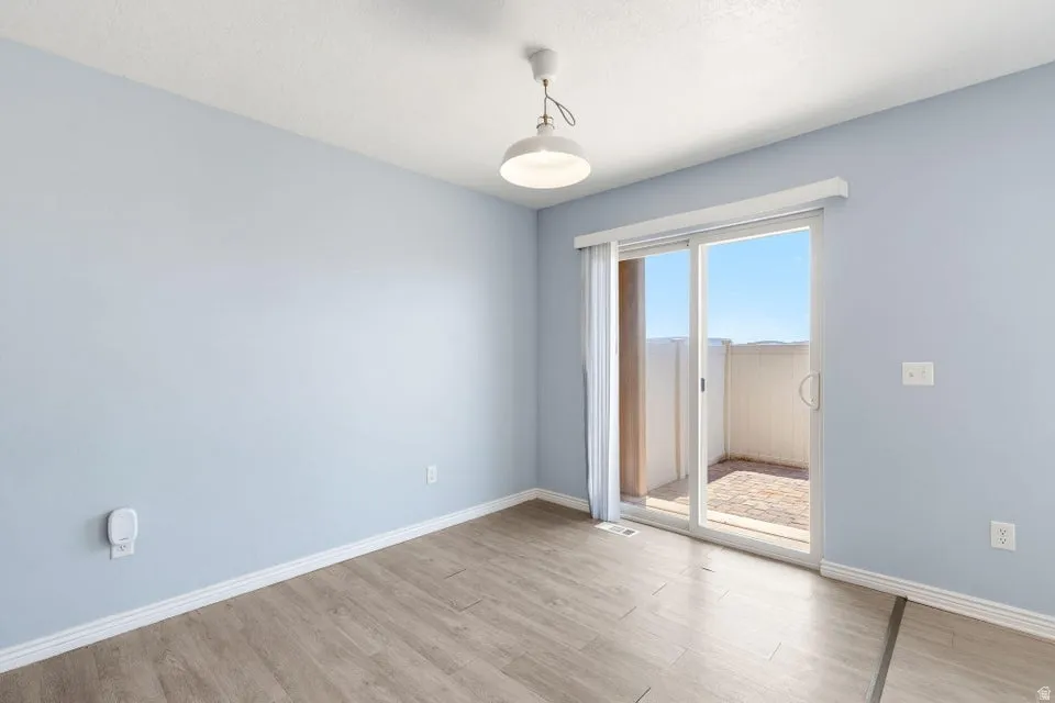 Light blue interior walls with wood-finish flooring