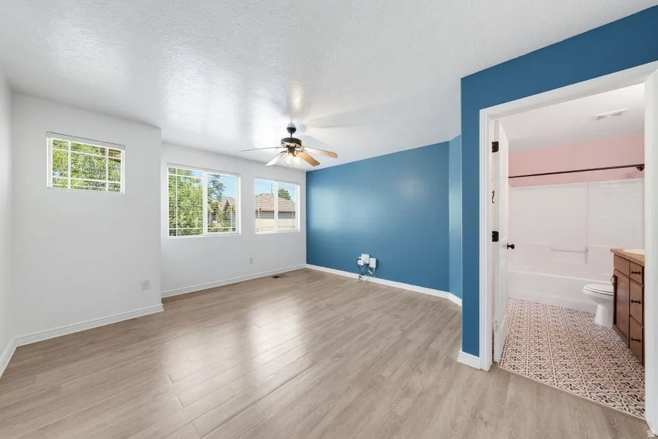 Bright and spacious room flooded with natural light through multiple casement windows