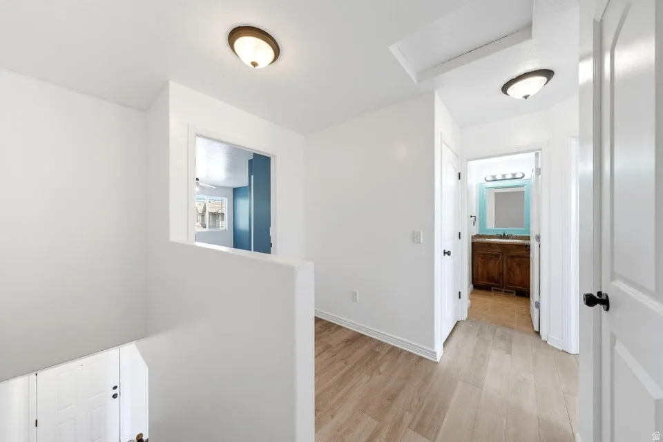 Wood-finish flooring throughout the hallway