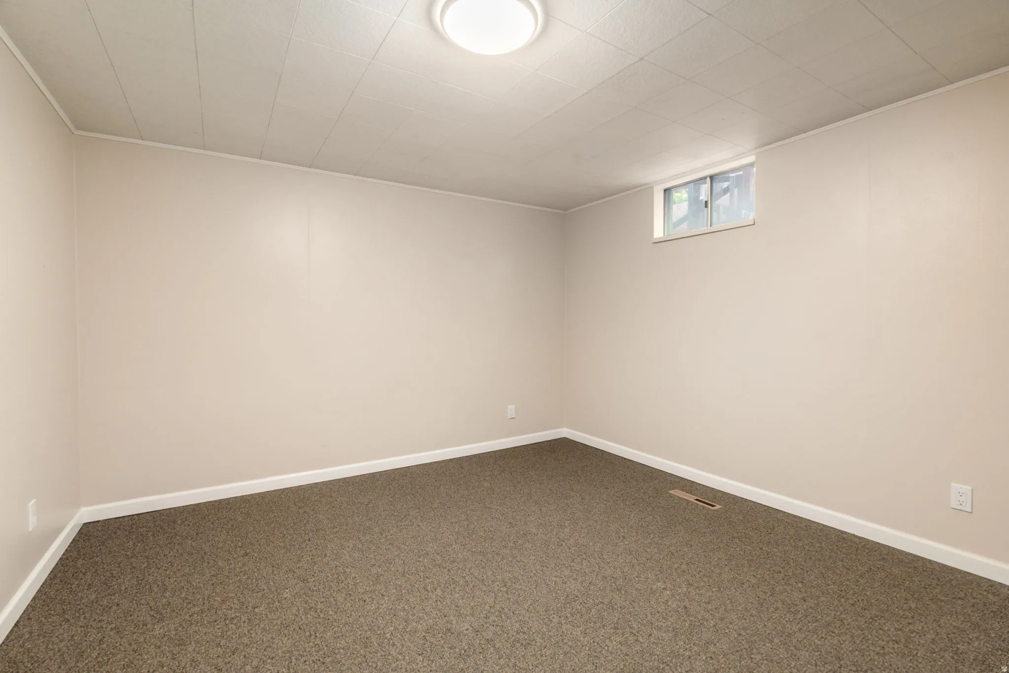 Finished basement room featuring neutral wall finishes, recessed ceiling lighting, and neutral-tone carpet flooring throughout