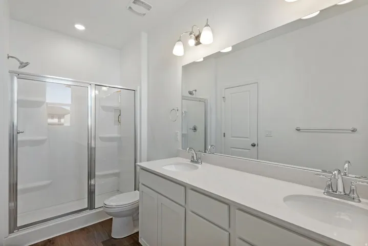 Dual vanity with undermount sinks, chrome fixtures, and a spacious mirror