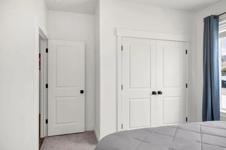 White paneled doors with black hardware