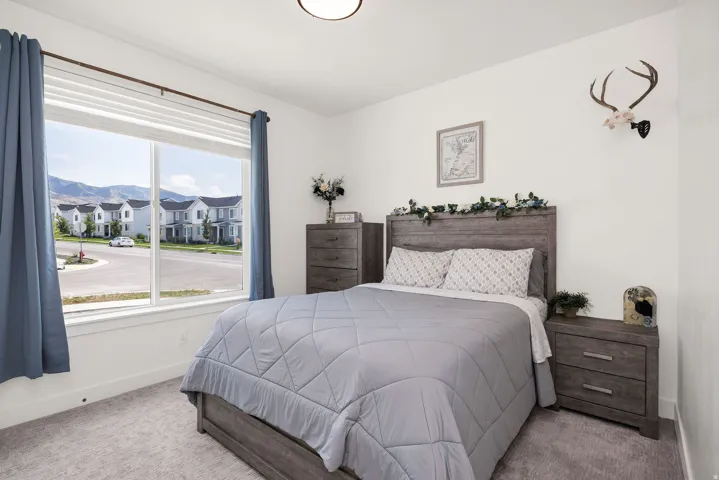 White walls with a single large window and a ceiling-mounted light fixture