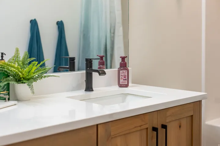 Integrated rectangular sink with a matte black faucet, set into a light-toned countertop