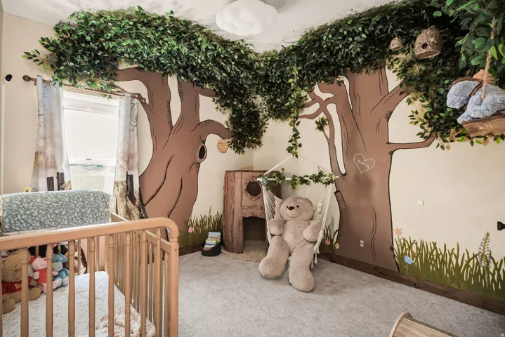 Carpeted room featuring custom wall art, window, and a built-in tree canopy with integrated lighting